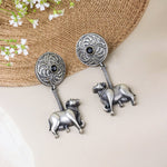 Load image into Gallery viewer, Black Stone Earrings with Cow Motif Dangle
