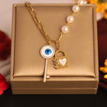 Load image into Gallery viewer, Evil Eye Lock &amp; Key Pearl Chain Necklace
